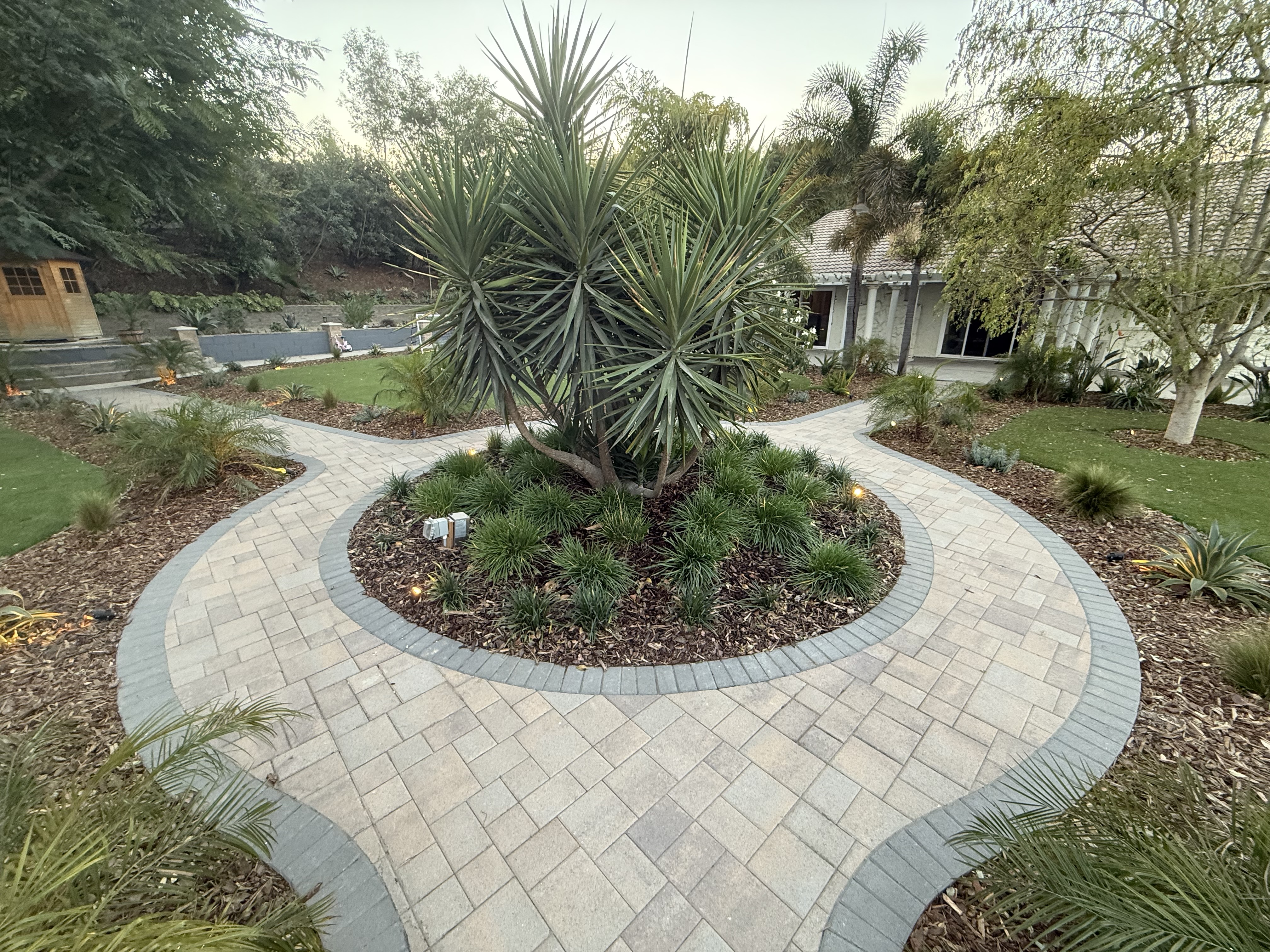 Curved paver walkway with tropical landscaping