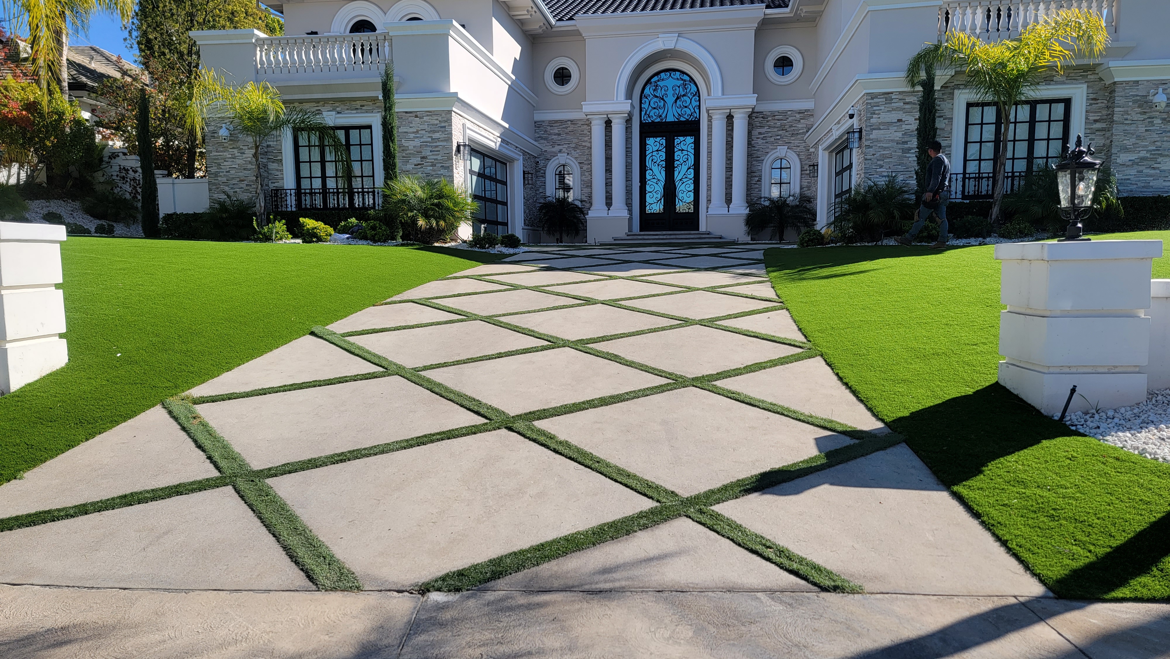 Luxury mansion front yard with artificial turf and diamond-cut pavers